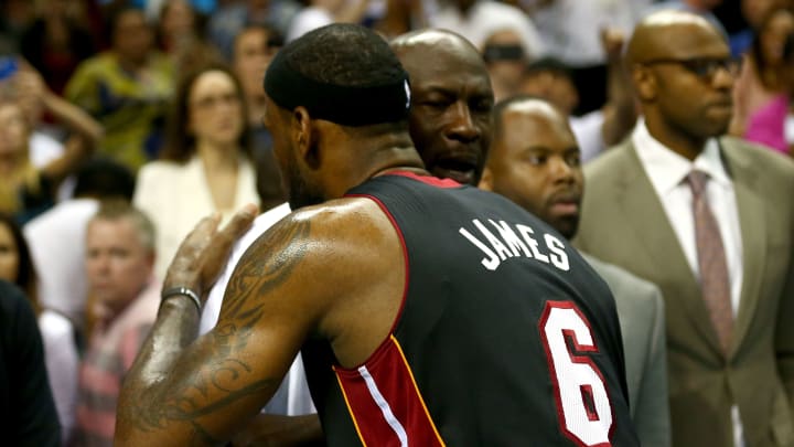 Michael Jordan congratulates LeBron James after winning Game 4 over the Charlotte Bobcats