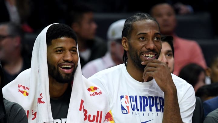 Paul George (L) and Kawhi Leonard (R) sitting on the Clippers' bench